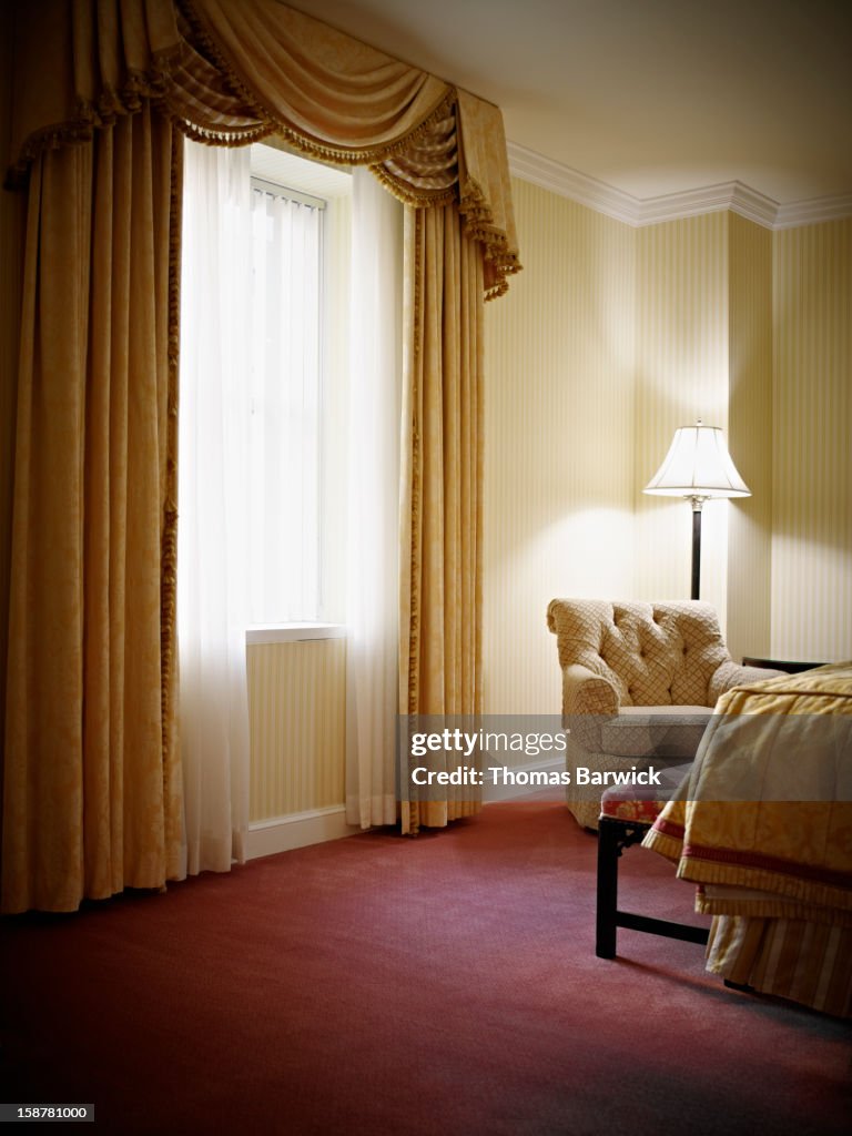 Empty bedroom in hotel suite