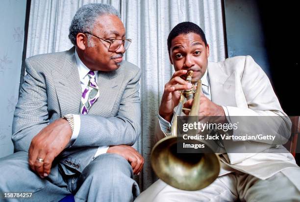 Portrait of American jazz musician Ellis Marsalis Jr and his son, fellow musician Wynton Marsalis, backstage after a rare performance as a duo at The...