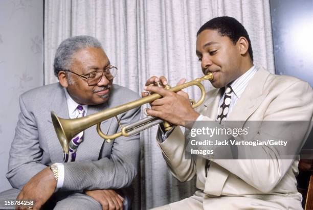 Portrait of American jazz musician Ellis Marsalis Jr and his son, fellow musician Wynton Marsalis, backstage after a rare performance as a duo at The...