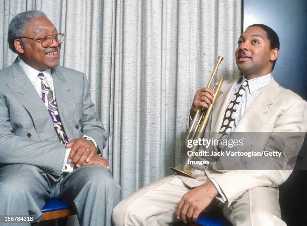 Portrait of American jazz musician Ellis Marsalis Jr and his son, fellow musician Wynton Marsalis, backstage after a rare performance as a duo at The...