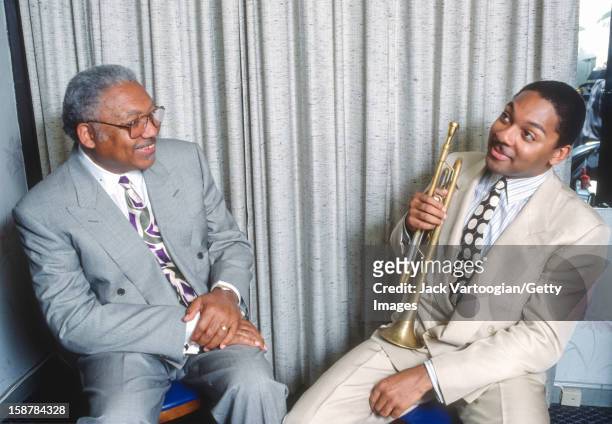 Portrait of American jazz musician Ellis Marsalis Jr and his son, fellow musician Wynton Marsalis, backstage after a rare performance as a duo at The...