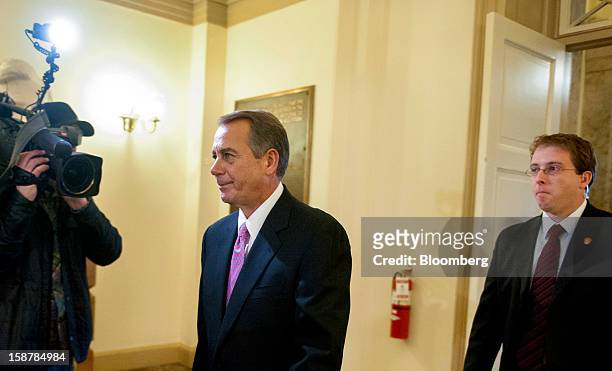 House Speaker John Boehner, a Republican from Ohio, center, walks to his office on Capitol Hill in Washington, D.C., U.S., on Friday, Dec. 28, 2012....