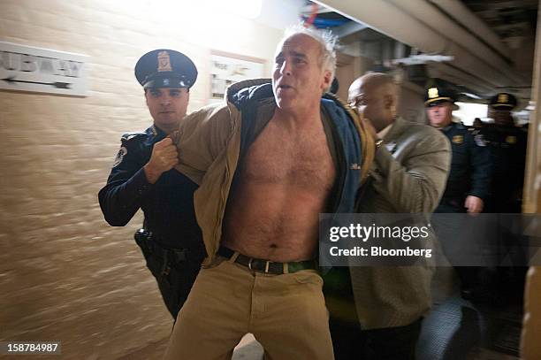 Protester Rives Grogan, who disrupted the U.S. Senate by shouting from the spectator's gallery, is removed from the Capitol building by police...