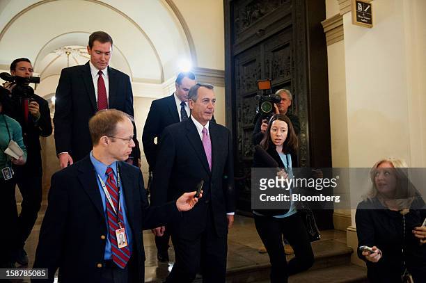House Speaker John Boehner, a Republican from Ohio, center, leaves the U.S. Capitol, surrounded by members of the media, on his way to a meeting with...