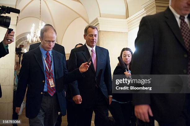 House Speaker John Boehner, a Republican from Ohio, center, leaves the U.S. Capitol, surrounded by members of the media, on his way to a meeting with...