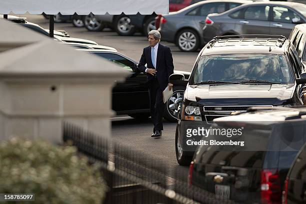 Senator John Kerry, a Democrat from Massachusetts, walks into the West Wing of the White House in Washington, D.C., U.S., on Friday, Dec. 28, 2012....