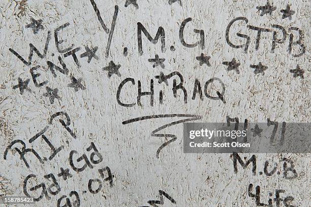 Graffiti is scrawled in the play lot where 16-year-old Jeffrey Stewart collapsed after being shot on December 9, in the Humboldt Park neighborhood on...