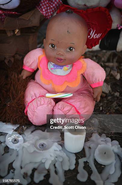 Doll and candles are part of a memorial for fifteen-year-old Porshe Foster November 27, 2012 in Chicago, Illinois. Foster died after being shot in...