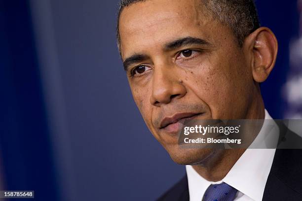 President Barack Obama pauses while speaking in the Brady Press Briefing Room at the White House in Washington, D.C., U.S., on Friday, Dec. 28, 2012....