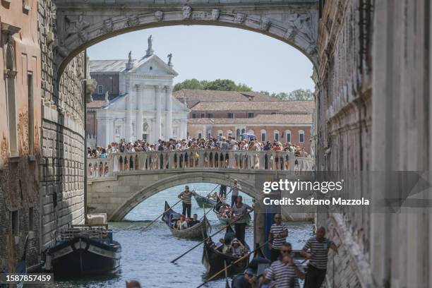 Gondolas slowly pass under the Bridge of Sighs near St. Mark's Square due to too much traffic on August 02, 2023 in Venice, Italy. UNESCO officials...