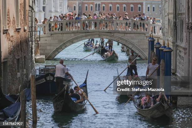 Gondoliers proceed slowly near the Sospiri Bridge near St. Mark's Square due to too much traffic on August 02, 2023 in Venice, Italy. UNESCO...