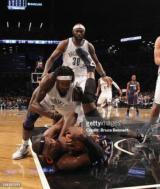 Gerald Wallace of the Brooklyn Nets and Brendan Haywood of the Charlotte Bobcats wrestle for the ball during the second quarter at the Barclays...