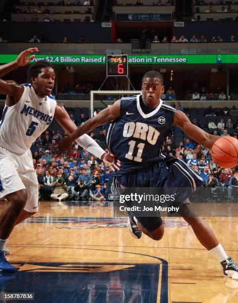 Shawn Glover of the Oral Roberts Golden Eagles drives against Shaq Goodwin of the Memphis Tigers on December 28, 2012 at FedExForum in Memphis,...