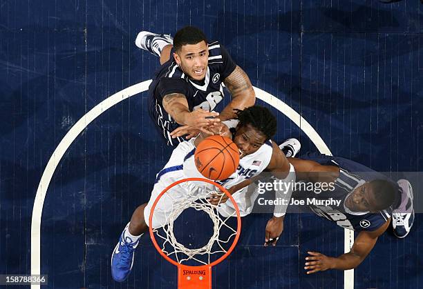 Shaq Goodwin of the Memphis Tigers shoots against Damen Bell-Holter and Brandon Conley of the Oral Roberts Golden Eagles on December 28, 2012 at...