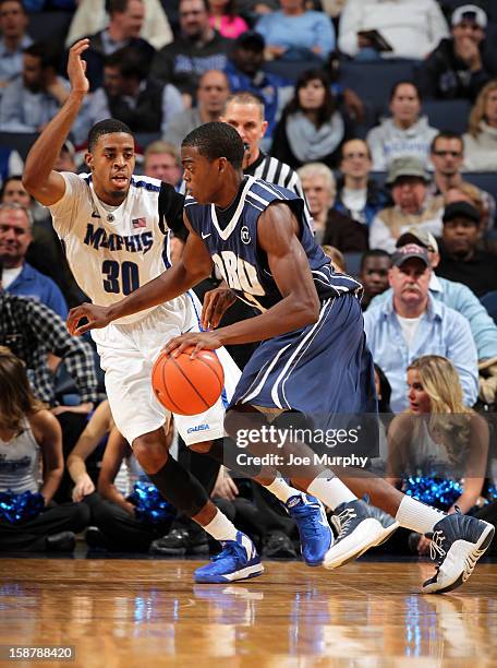 Shawn Glover of the Oral Roberts Golden Eagles drives against D.J. Stephens of the Memphis Tigers on December 28, 2012 at FedExForum in Memphis,...