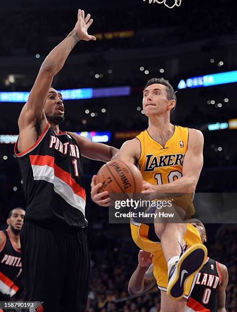 Steve Nash of the Los Angeles Lakers drives on Jared Jeffries of the Portland Trail Blazers at Staples Center on December 28, 2012 in Los Angeles,...