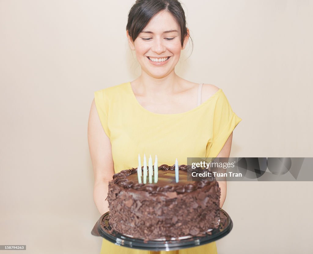 Woman holding birthday cake