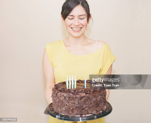 woman holding birthday cake - holding birthday cake stock pictures, royalty-free photos & images