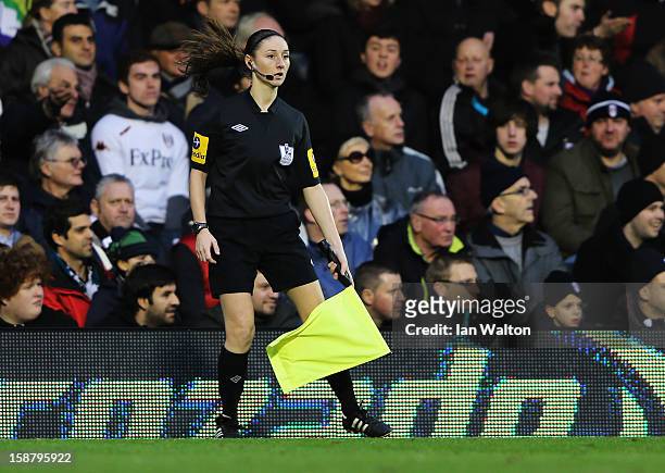Assistant referee Sian Massey runs the line during the Barclays Premier League match between Fulham and Swansea City at Craven Cottage on December...