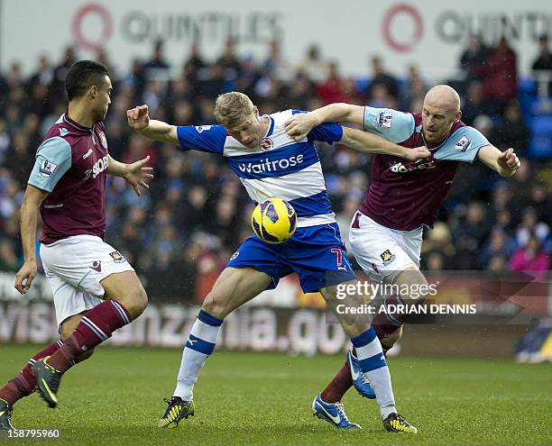 Reading's Russian striker Pavel Pogrebnyak vies with West Ham United's Welsh defender James Collins and New Zealand defender WInston Reid during the...