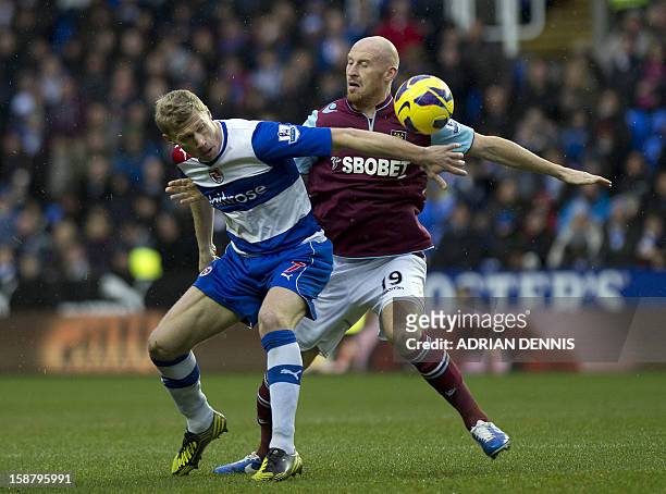 Reading's Russian striker Pavel Pogrebnyak vies with West Ham United's Welsh defender James Collins during the English Premier League football match...