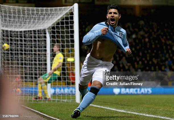 Sergio Aguero of Manchester City celebrates scoring his side's third goal during the Barclays Premier League match between Norwich City and...