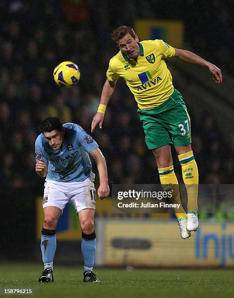 Harry Kane of Norwich City heads the ball during the Barclays Premier League match between Norwich City and Manchester City at Carrow Road on...