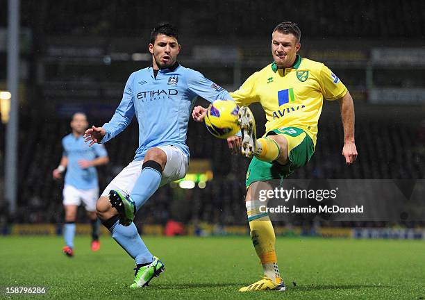 Sergio Aguero of Manchester City and Russell Martin of Norwich City battle for the ball during the Barclays Premier League match between Norwich City...