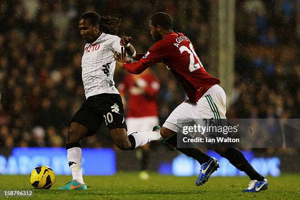 Hugo Rodallega of Fulham holds off the challenge of Kemy Agustien of Swansea City during the Barclays Premier League match between Fulham and Swansea...