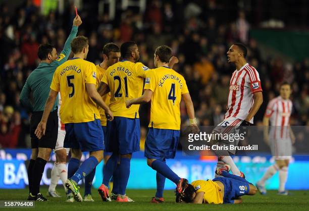 Steven Nzonzi of Stoke City is sent-off by referee Mark Clattenburg for fouling Jack Cork of Southampton, who lies injured on the floor during the...