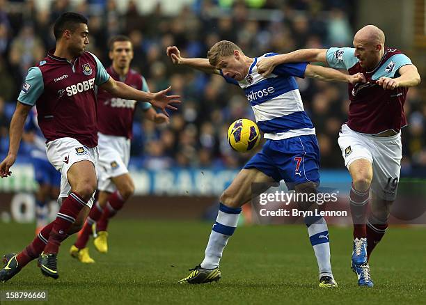 Pavel Pogrebnyak of Reading battles with James Collins of West Ham United during the Barclays Premier League match between Reading and West Ham...