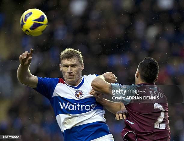 Reading's Russian striker Pavel Pogrebnyak vies for the ball against West Ham United's New Zealand defender Winston Reid during the English Premier...