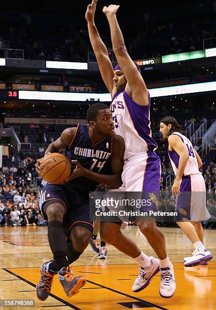 Michael Kidd-Gilchrist of the Charlotte Bobcats handles the ball during the NBA game against the Phoenix Suns at US Airways Center on December 19,...