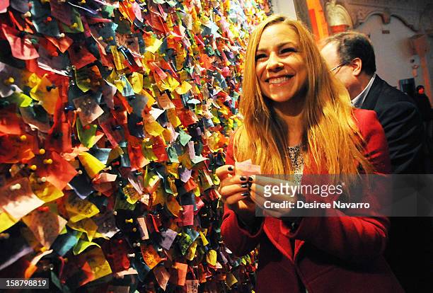 Personality Allison Hagendorf reads wishes on the Wishing Wall at the New Year's Eve 2013 Confetti Airworthiness Test at Times Square Alliance...