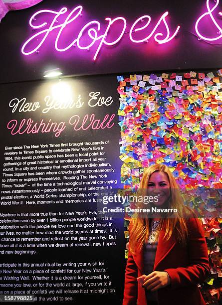 Personality Allison Hagendorf poses in front of the Wishing Wall at the New Year's Eve 2013 Confetti Airworthiness Test at Times Square Alliance...