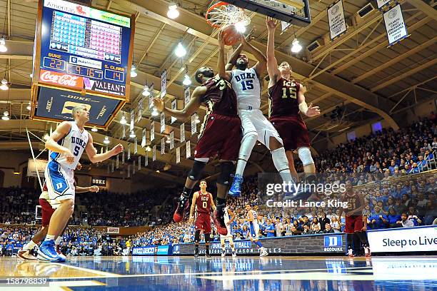 Josh Hairston of the Duke Blue Devils goes to the hoop against Robert Garrett and Marc Trasolini of the Santa Clara Broncos at Cameron Indoor Stadium...