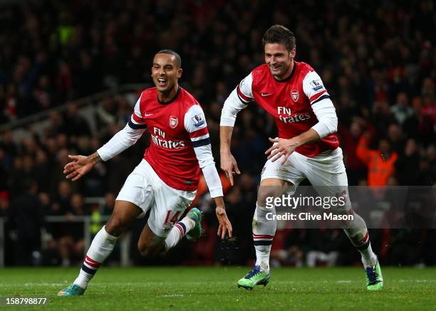Theo Walcott of Arsenal celebrates scoring his hat trick and Arsenal's seventh goal with Olivier Giroud of Arsenal during the Barclays Premier League...