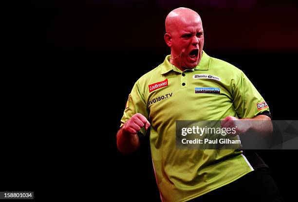 Michael van Gerwen of Netherlands celebrates winning a set during the quarter final match between Adrian Lewis of England and Michael Van Gerwen of...