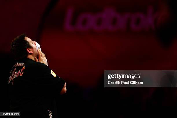 Adrian Lewis of England looks dejected after losing the quarter final match between Adrian Lewis of England and Michael Van Gerwen of Netherlands on...