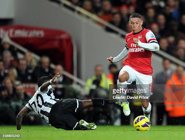 Alex Oxlade-Chamberlain of Arsenal skips past Gael Bigirimana of Newcastle during the Barclays Premier League match between Arsenal and Newcastle...