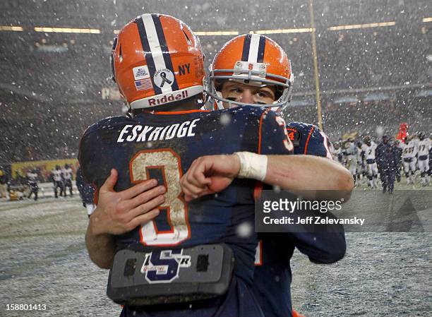 Ryan Nassib and Durell Eskridge of the Syracuse Orange celebrate victory over the West Virginia Mountaineers in the New Era Pinstripe Bowl at Yankee...