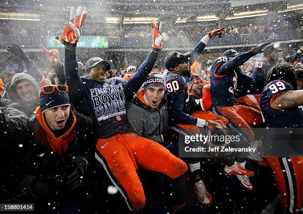 Members of the Syracuse Orange celebrate with fans after their win over the West Virginia Mountaineers in the New Era Pinstripe Bowl at Yankee...