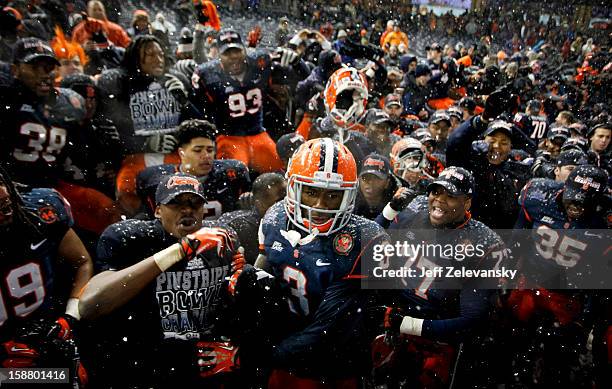 Members of the Syracuse Orange celebrate with fans after their win over the West Virginia Mountaineers in the New Era Pinstripe Bowl at Yankee...