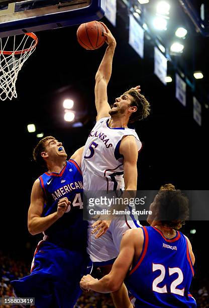Jeff Withey of the Kansas Jayhawks dunks over Tony Wroblicky of the American University Eagles during the game at Allen Fieldhouse on December 29,...