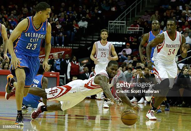 Toney Douglas of the Houston Rockets dives for a ball against the Oklahoma City Thunder at the Toyota Center on December 29, 2012 in Houston, Texas....