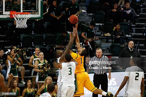 Paris Bennett of the George Mason Patriots shoots over Toarlyn Fitzpatrick and Zach LeDay of the South Florida Bulls during the game at the Sun Dome...