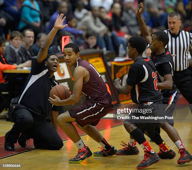 North Point's head coach Jimmy Ball, left, shouts instructions as Sidwell's Aaron Washington, center left, works his way throught the defense of...