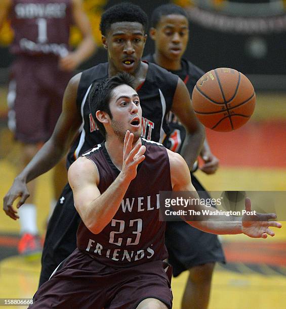 Sidwell's Matt Hillman, center, gains control of a loose ball as North Point's Naim Muhammad defends during North Point playing Sidwell Friends in...