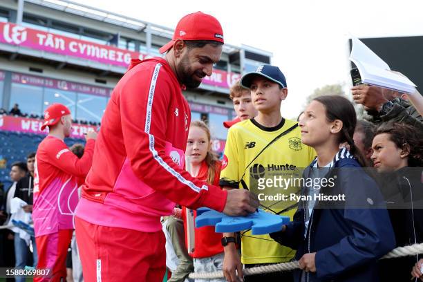 Haris Rauf of Welsh Fire signs memorabilia and autographs for spectators after defeating Manchester Originals during The Hundred match between Welsh...