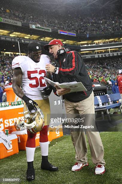 Linebackers Coach Jim Leavitt of the San Francisco 49ers talks with Patrick Willis during the game against the Seattle Seahawks at CenturyLink Field...